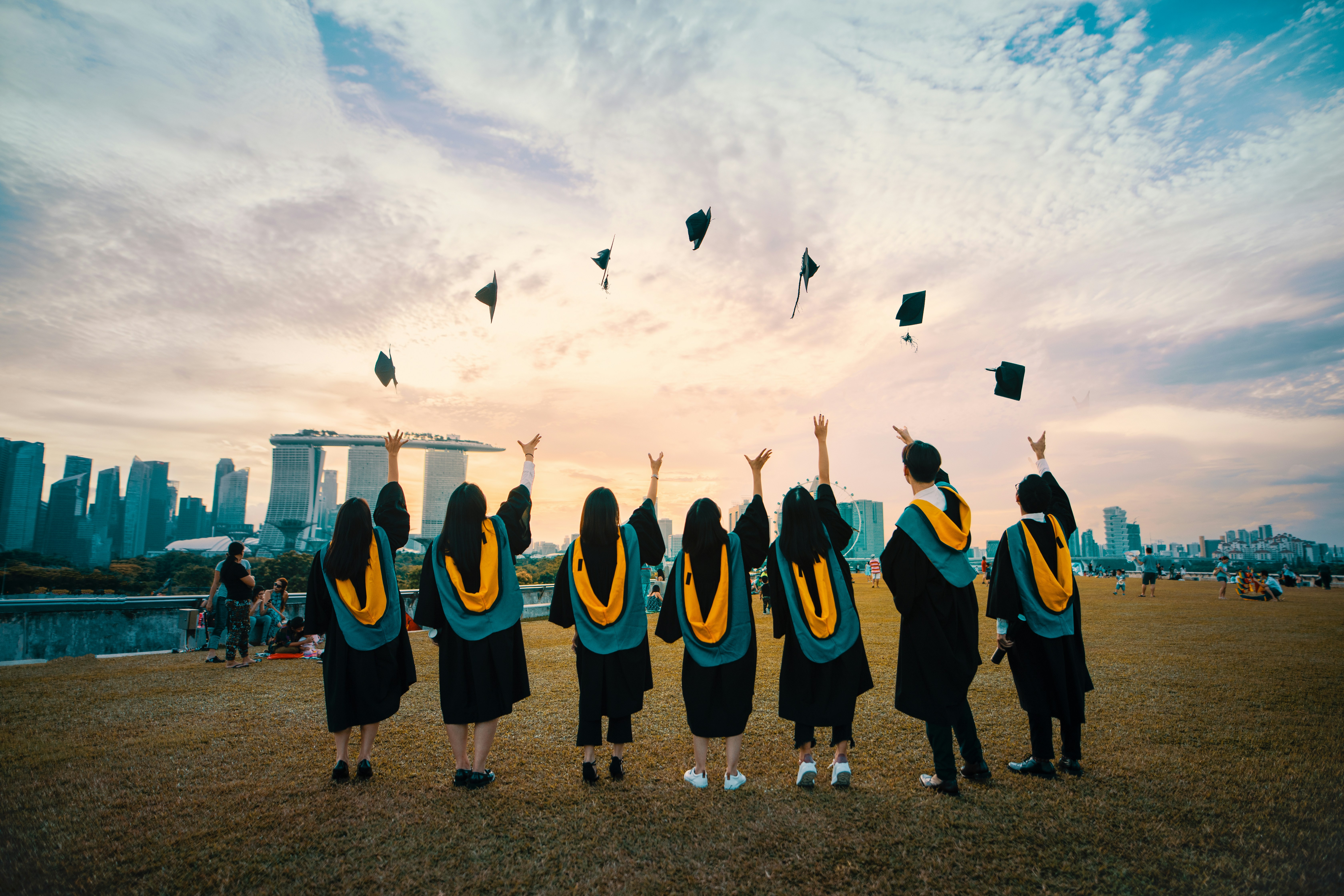 Students throwing graduation caps in the air